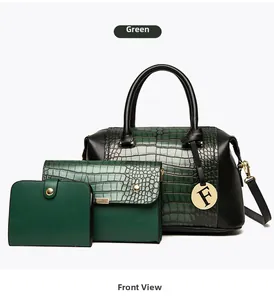 Detail of green embossed crocodile texture handbag set with golden hardware and metal tag