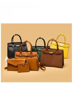 Detail of multi-piece vintage embossed leather handbag set with gold hardware locks