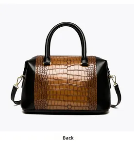 Rear view of brown crocodile texture and black leather handbag with gold metal hardware