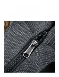 Detail of high-quality YKK metal zipper on textured grey canvas tote bag close-up
