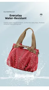 Red waterproof canvas tote bag with brown handles showing splash resistance on blue background