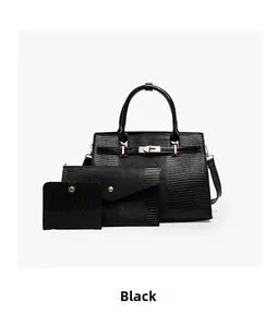 Close-up of black lizard pattern 3-piece bag set with gold hardware and flap closure