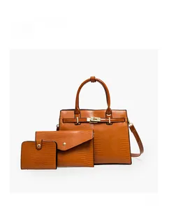 Three-piece brown embossed lizard pattern handbag set including tote and clutch bags