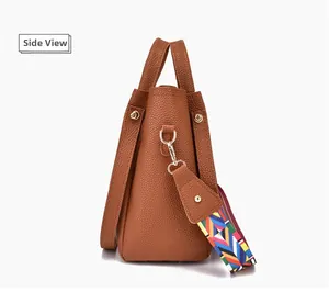 Seitenansicht der braunen Handtasche aus Narbenleder mit buntem gewebtem Schultergurt