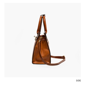Side view detail of a brown crocodile embossed tote bag with gold metal hardware