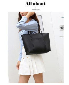 Dettaglio della borsa tote minimalista in pelle martellata nera con cuciture verticali