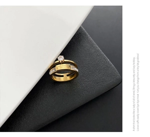 Detail of gold double-layered zircon ring with Love Forever Est. 1981 engraved plate