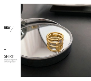 Macro shot of gold-plated triple-layered zircon ring with Love Forever engraving