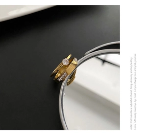 Detail view of gold zircon ring set with Love Forever engraving and mirror reflection