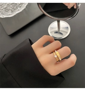 Close-up of a gold zircon ring set with a solitaire stone and a pave-diamond band