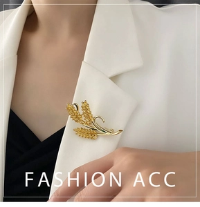 Macro detail of a golden wheat brooch with zircon stones on a white suit jacket