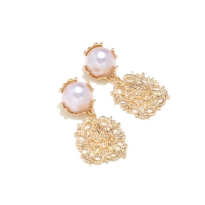 Detail of vintage lion earrings with pearl studs and intricate baroque gold hollow charms