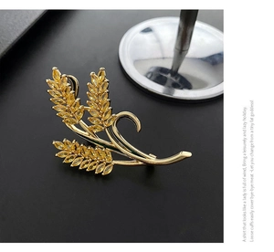 Detailed close-up of golden wheat brooch featuring yellow marquise-cut zircon stones