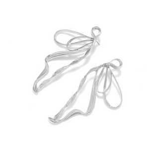 Polished silver flowing ribbon bow earrings with a modern minimalist metallic finish