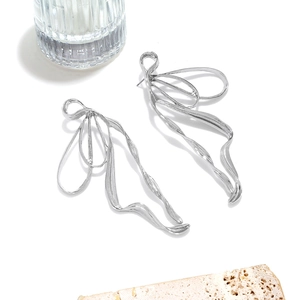 Polished silver abstract ribbon earrings with a minimalist flowing butterfly wing design