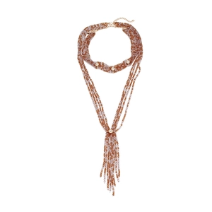 Close-up of bohemian multilayered beaded necklace with gold accents and fringe tassel