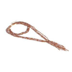 Detail of bohemian multilayer beaded necklace with tassels and crystal accents on white background