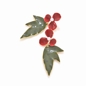 Exaggerated floral drop earrings with red enamel flowers and green spotted leaves