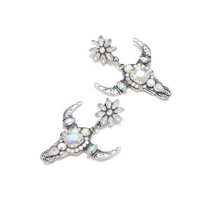Detail of western style ox skull earrings with colorful rhinestones on silver base