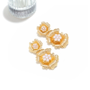 Exaggerated gold floral earrings with imitation pearl accents and brushed metal texture