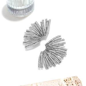 Macro shot of silver fan-shaped earrings with rows of sparkling pavé crystals