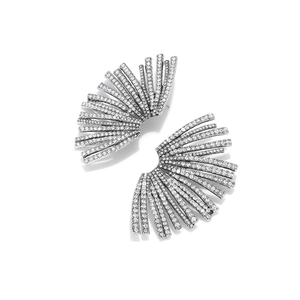 Macro detail of silver fan-shaped earrings with sparkling white crystals and radiant lines