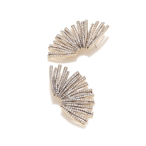 Detailed view of fan-shaped gold earrings with radiating lines and micro-pave crystals
