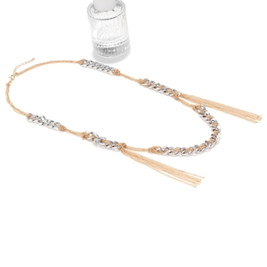 Detail of multi-layered mixed metal fringe necklace with gold and silver chain tassels