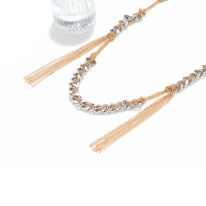 Statement layered mixed-metal tassel necklace with gold and silver tone woven chains