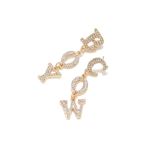 Detail shot of gold-plated cowboy letter earrings with sparkling white rhinestones