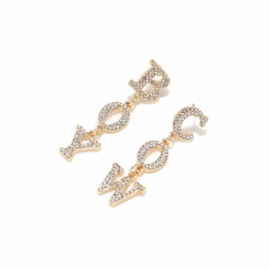 Macro shot of gold-plated COWBOY drop earrings with sparkling rhinestone crystals