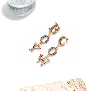Detail of western cowboy drop earrings with colorful rhinestones on gold-tone metal base