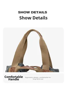 Detailed close-up of khaki webbing handle with brown leather trim on a grey canvas tote bag