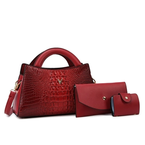 Three-piece dark red crocodile embossed handbag set with gold V-logo and matching pouches