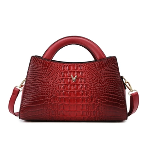Deep red crocodile embossed tote bag with gold V-logo and round handles on white background