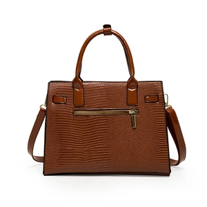 Caramel brown embossed leather handbag with top handle and adjustable shoulder strap