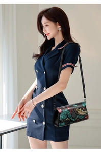 Detail of floral embossed leather crossbody bag with colorful koi fish patterns