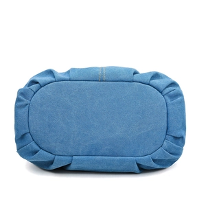 Blue denim canvas tote bag bottom view showing oval base and neat pleated stitching