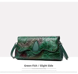 Detail view of green embossed leather bag featuring Chinese style koi and lotus patterns