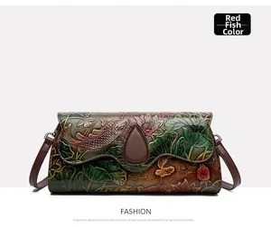 Detailed close-up of Chinese style embossed koi fish and lotus on brown leather bag