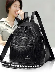 Detail of black lychee grain leather backpack with double front zippers and wide strap