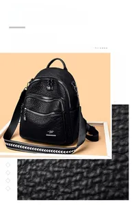 Detail of black lychee texture leather backpack with kangaroo logo and silver zippers
