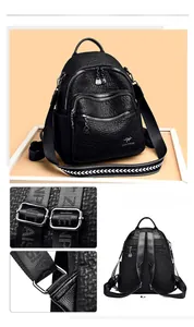 Detail of black pebbled leather backpack showing multi-pocket zippers and adjustable strap