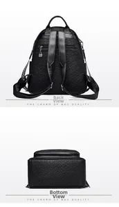 Detail view of the black textured faux leather backpack showing back pocket and bottom