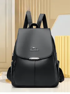 Detail of black faux leather backpack featuring metallic kangaroo logo and side pockets