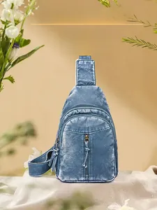Close-up of vintage blue washed leather chest bag with multi-pocket zippers and adjustable strap