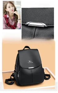 Detail of black lychee grain leather backpack with kangaroo metal logo and side pocket