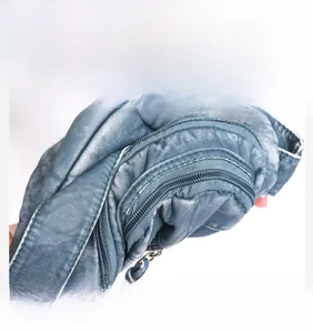Detailed close-up of premium washed leather texture with durable double stitching on bag