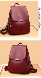 Close-up of wine red backpack featuring lychee grain leather and metal logo detail