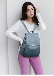 Close-up of litchi texture faux leather backpack with metallic kangaroo logo detail
